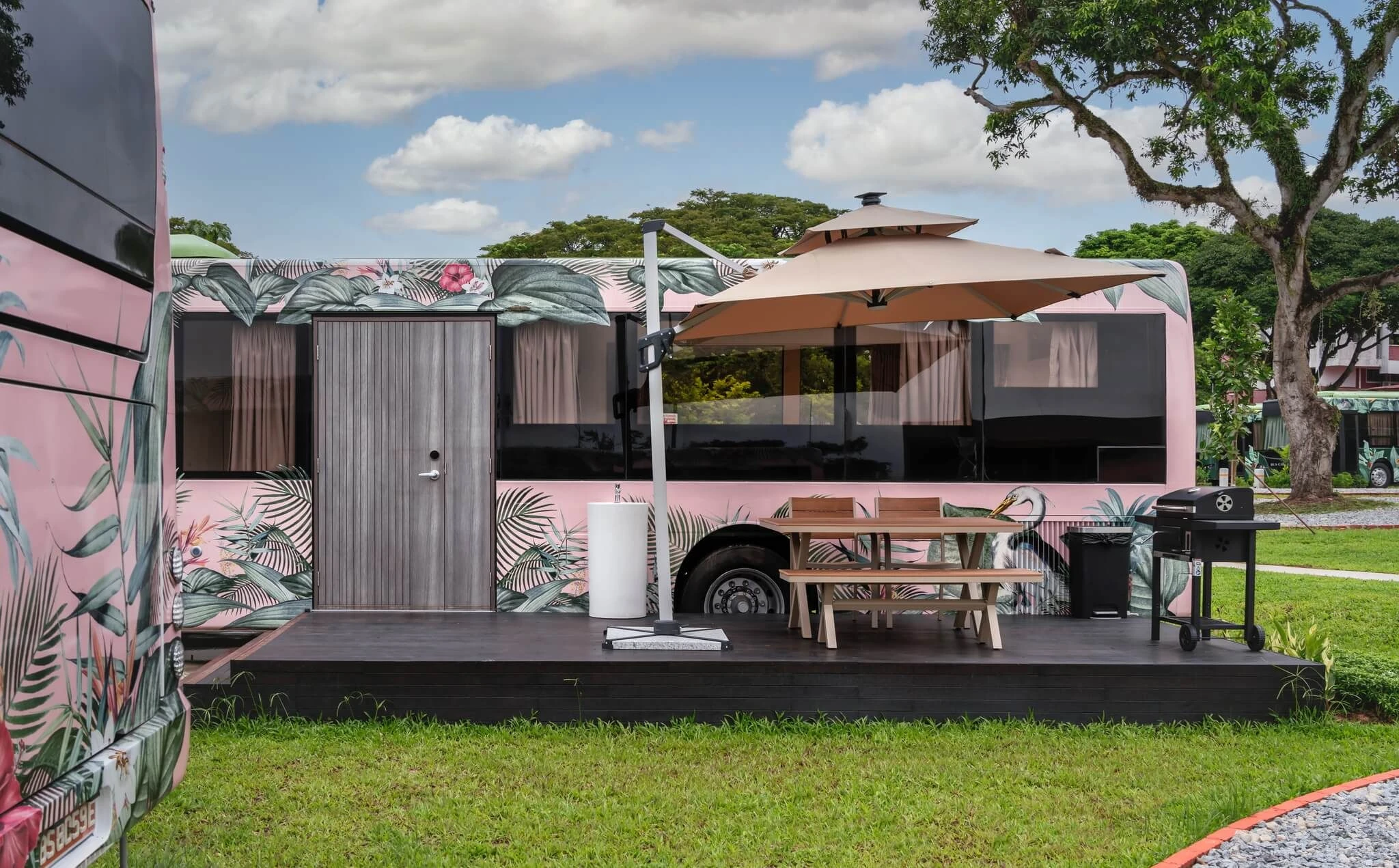 Private dining patio and barbecue beside an upcycled suite at The Bus Collective